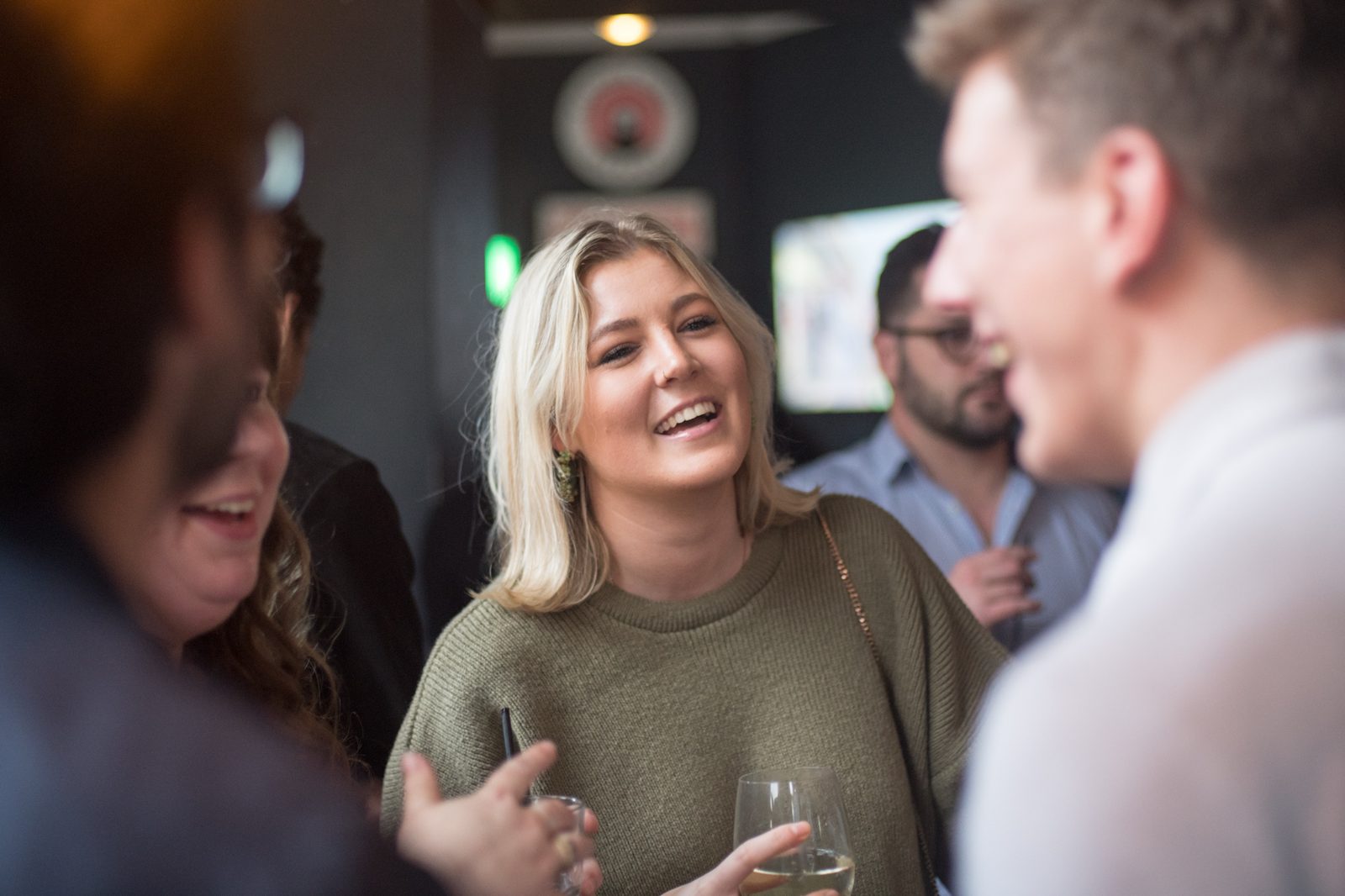 People smiling and chatting together in a pub