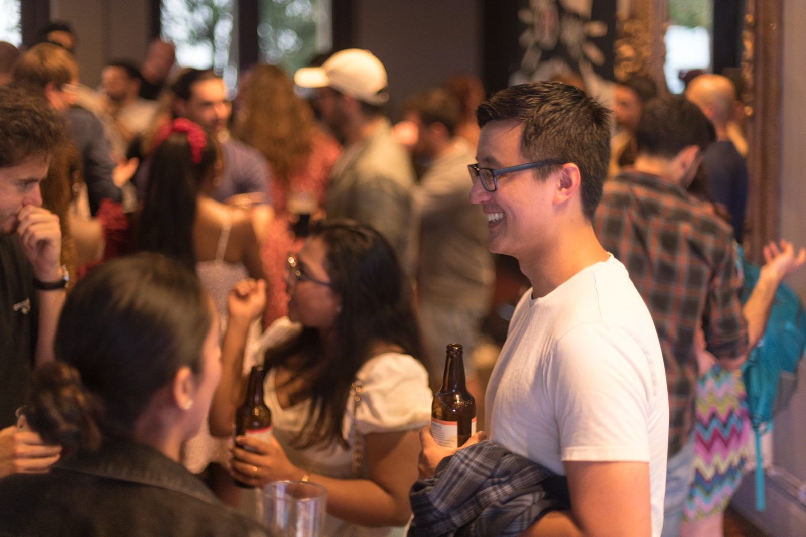 People chatting at a busy social event