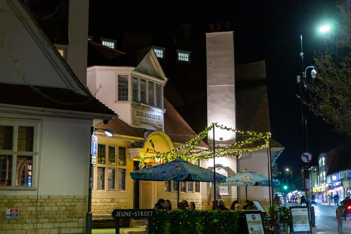 The Big Society exterior and outdoor seating at night