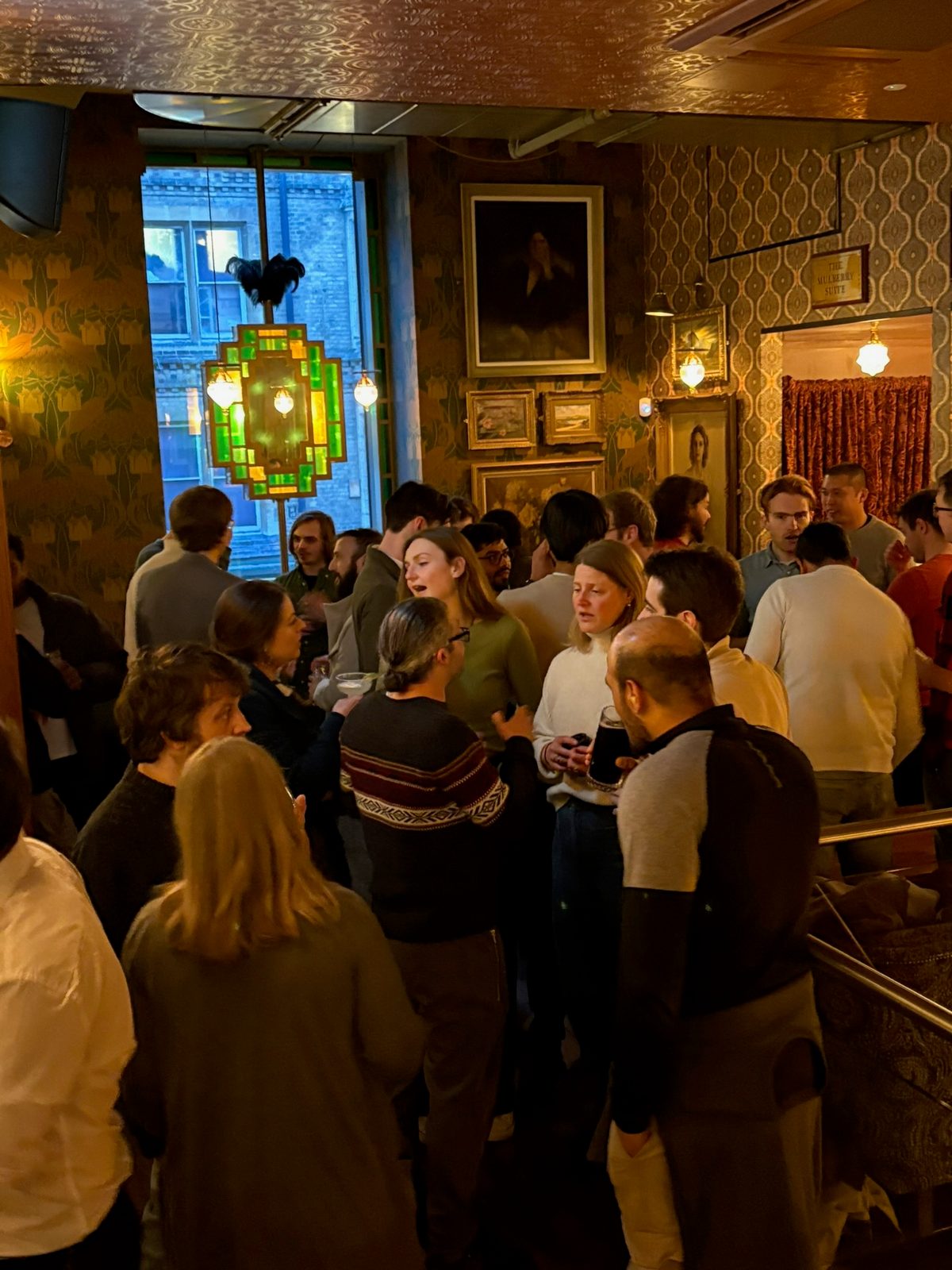 People chatting together in a warmly lit indoor venue