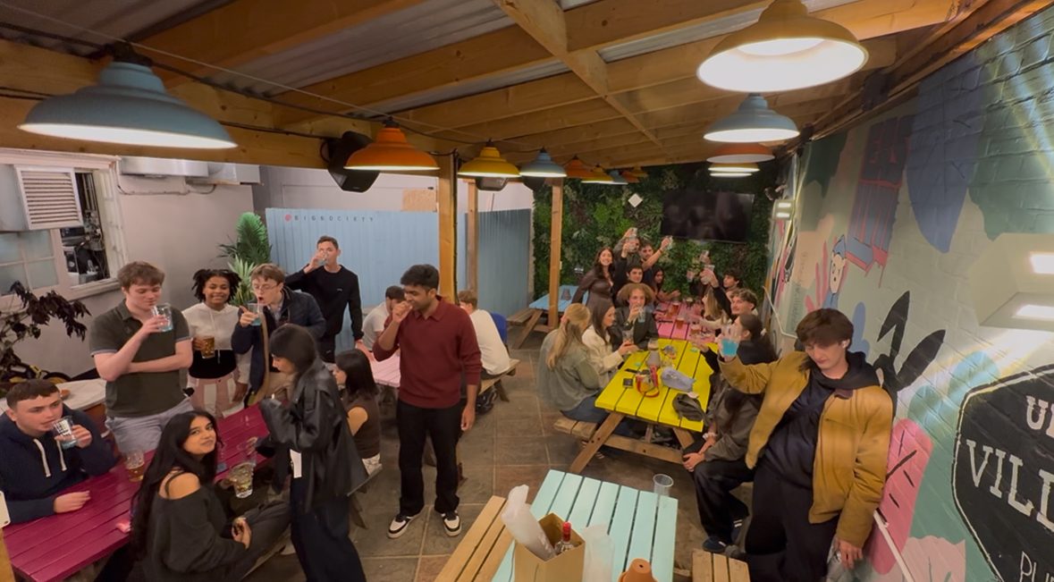 People gathered around colourful picnic tables at the Discover Oxford Scavenger Hunt